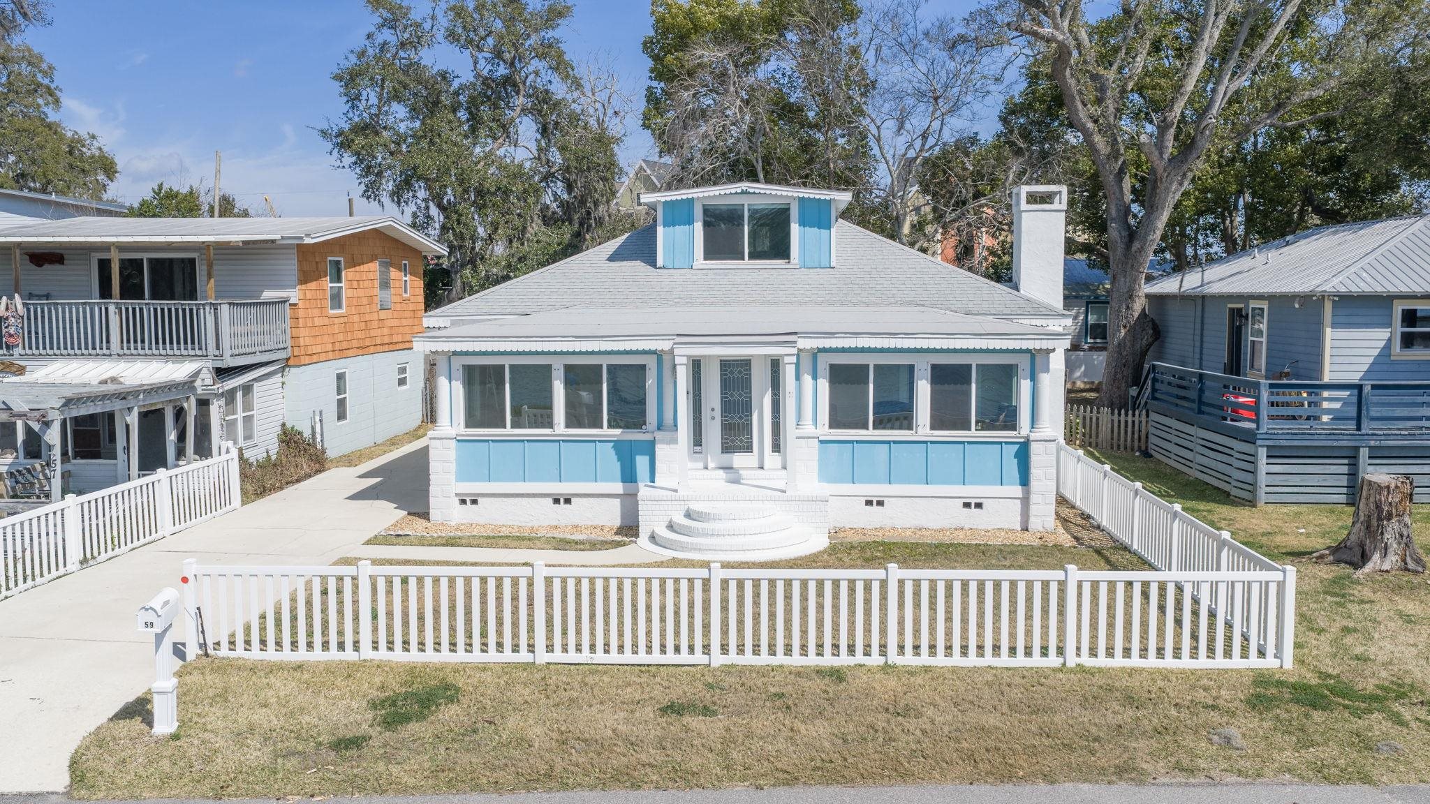 59 Lewis Boulevard St. Augustine, FL 32084 - Photo 42 of 75 Front of home featuring crawl space, a sunroom, roof with shingles, and driveway