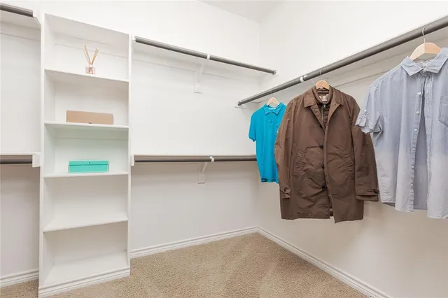 a view of a storage & utility room with refrigerator and cabinet