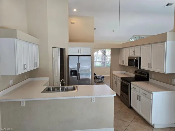 a kitchen with stainless steel appliances a sink stove and cabinets