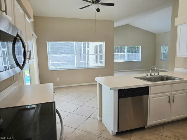 a utility room with cabinets dryer and washer