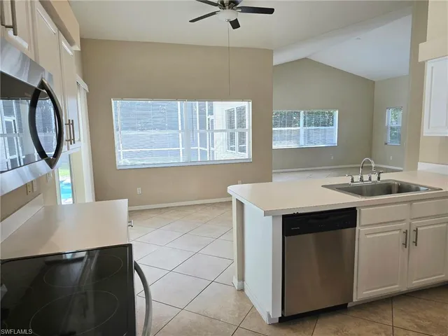 a utility room with cabinets dryer and washer