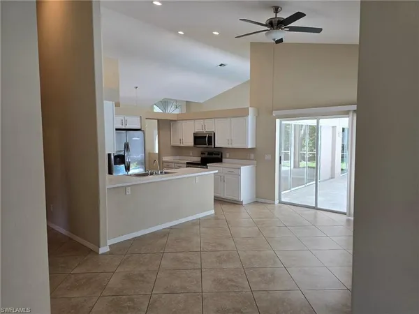a view of a kitchen with microwave and cabinets