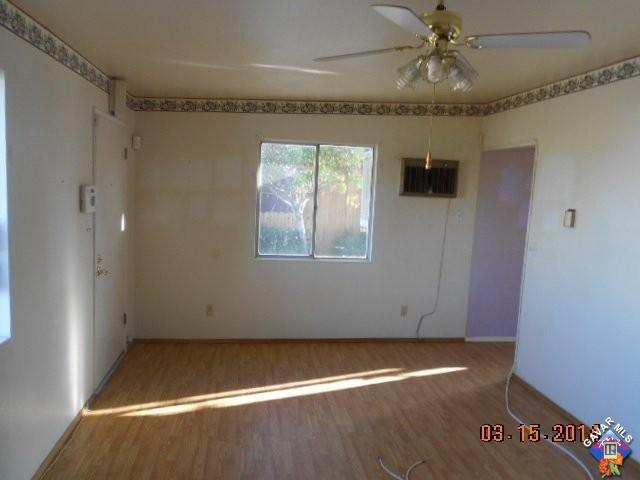 1233 South McCall Street Ridgecrest, CA 93555 - Photo 2 of 8 en empty room with windows and fan