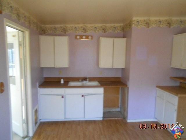 1233 South McCall Street Ridgecrest, CA 93555 - Photo 3 of 8 a kitchen with a sink and cabinets