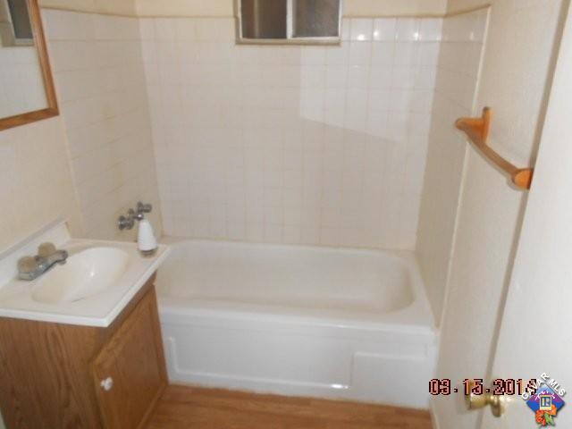 1233 South McCall Street Ridgecrest, CA 93555 - Photo 5 of 8 a bathroom with a bathtub and a sink
