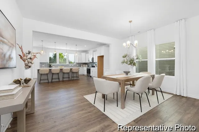 a dining room with furniture wooden floor and a rug