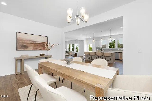 a view of a dining room with furniture and a chandelier