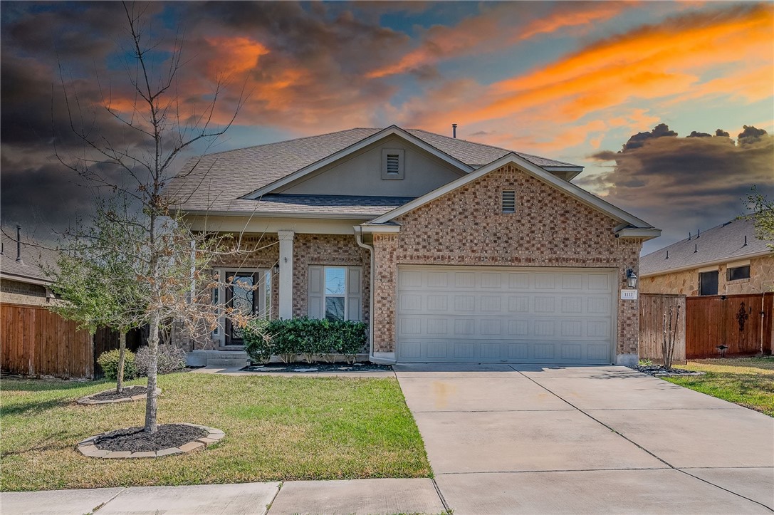 1112 April Meadows Loop Georgetown, TX 78626 - Photo 1 of 1 a front view of a house with garden