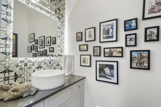 a living room with furniture and painting on the wall