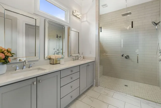 a bathroom with a shower sink and mirror