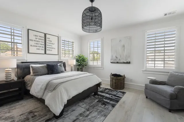 a bedroom with bed furniture and a window