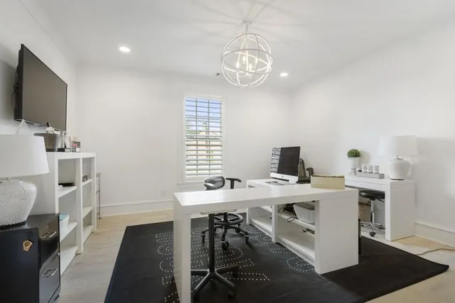 a view of a dining room with furniture a rug and wooden floor