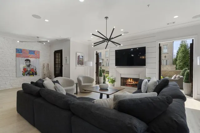a living room with fireplace furniture and a flat screen tv