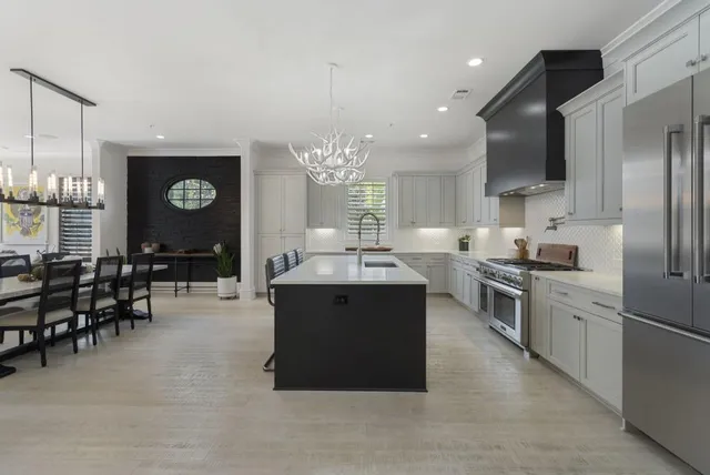 a kitchen with stainless steel appliances granite countertop a sink stove and cabinets