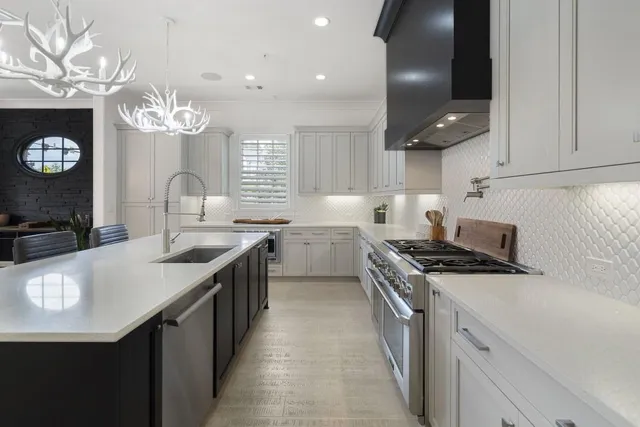 a kitchen with a sink stove and cabinets