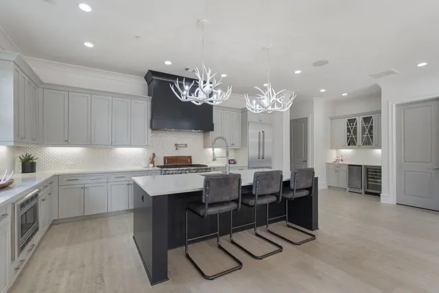 a kitchen with cabinets and chairs