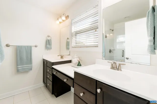 a bathroom with a sink double vanity and a mirror