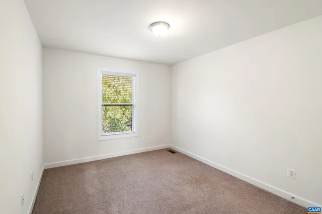 a view of a hallway with wooden floor and entryway