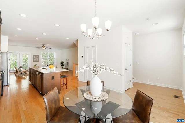 a living room with kitchen island furniture and a chandelier