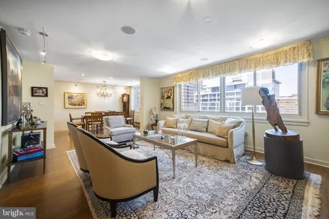 a living room with furniture and a floor to ceiling window