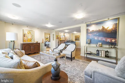 a living room with furniture fireplace and a large window