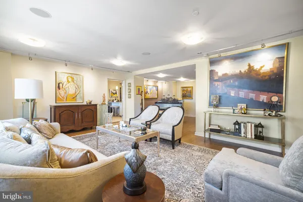 a living room with furniture fireplace and a large window