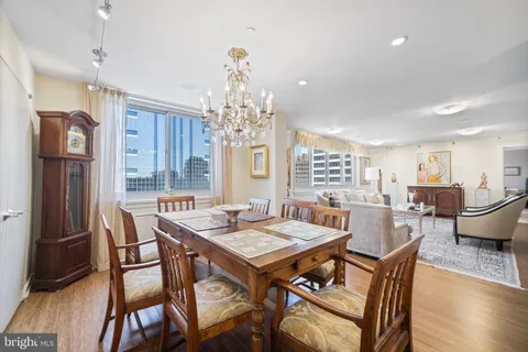 a dining room with a wooden table and chairs