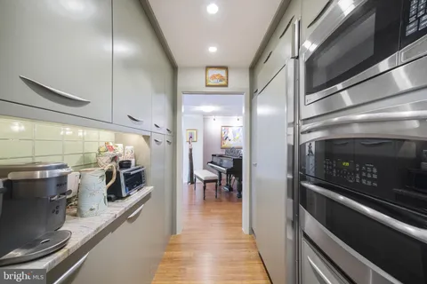 a large kitchen with stainless steel appliances lots of counter space and a sink