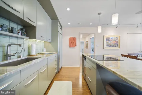 a kitchen with a refrigerator and a stove