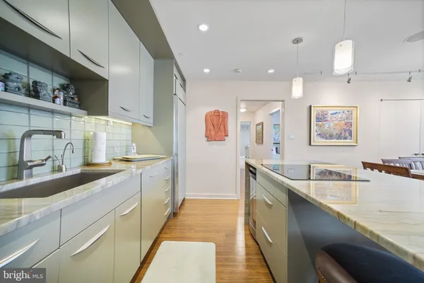 a kitchen with a refrigerator and a stove