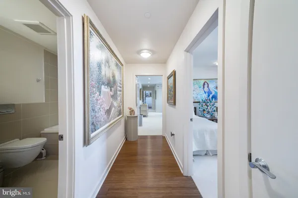 a bedroom with two beds and a painting on the wall