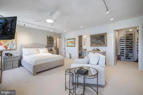 a bathroom with a granite countertop double vanity sink a mirror and a shower