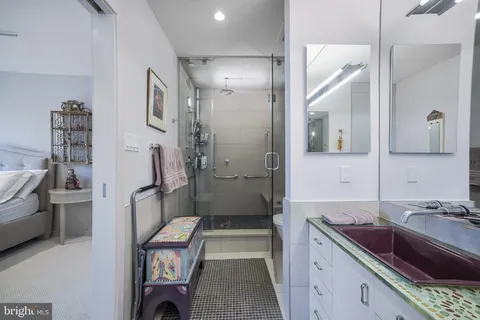a spacious bathroom with a granite countertop sink and a mirror