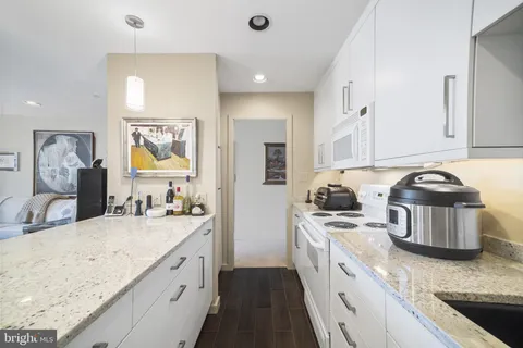 a kitchen with a sink appliances and cabinets