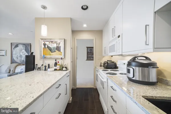 a kitchen with a sink appliances and cabinets