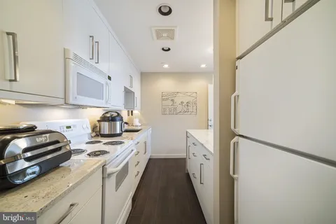 a white toilet sitting next to a bathroom sink