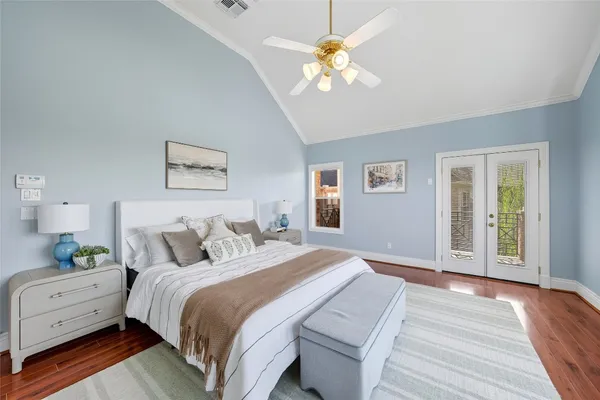 a bedroom with a bed and a chandelier