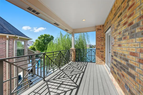 a view of balcony with wooden floor and fence