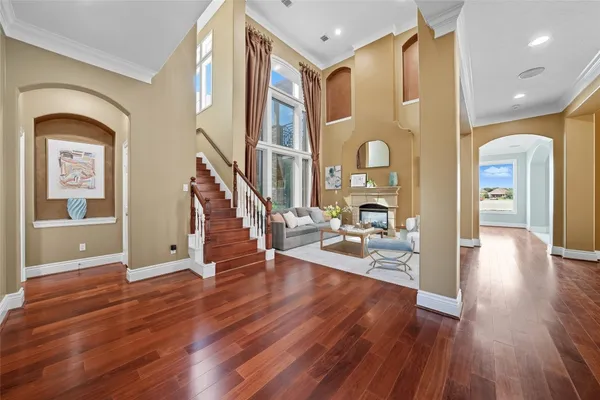a living room with fireplace furniture and a wooden floor