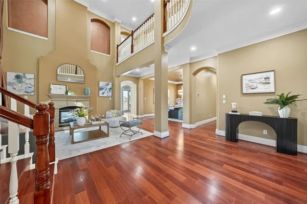 a living room with fireplace furniture and a wooden floor