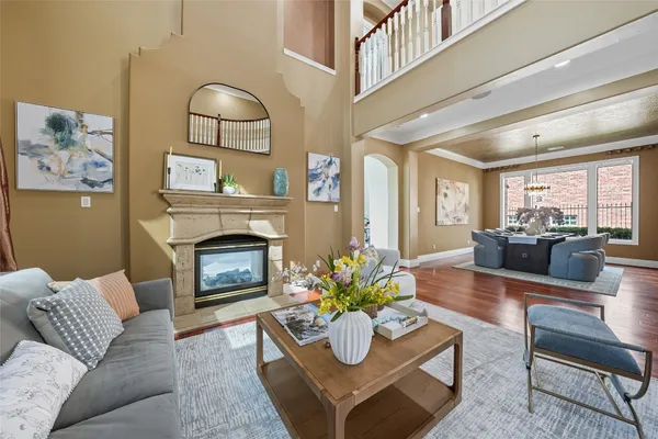 a living room with furniture a rug and a chandelier