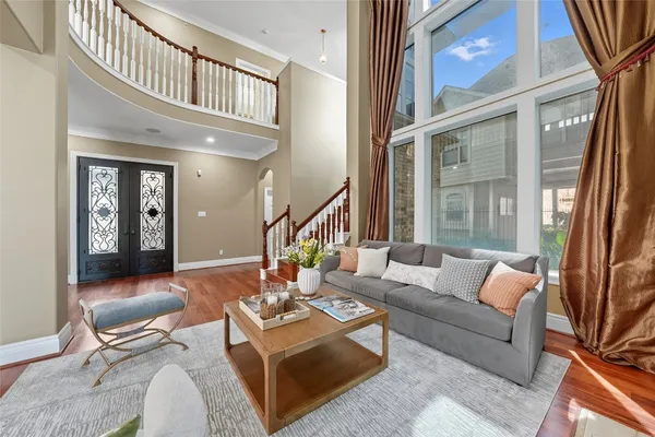 a dining room with wooden floor and white walls