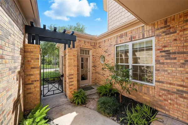 a front view of a house with yard and green space