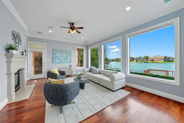 a living room with fireplace furniture and a large window
