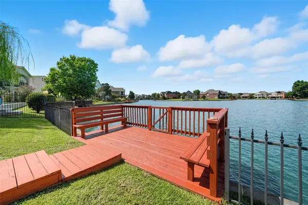 a view of a chairs and table in patio with wooden fence
