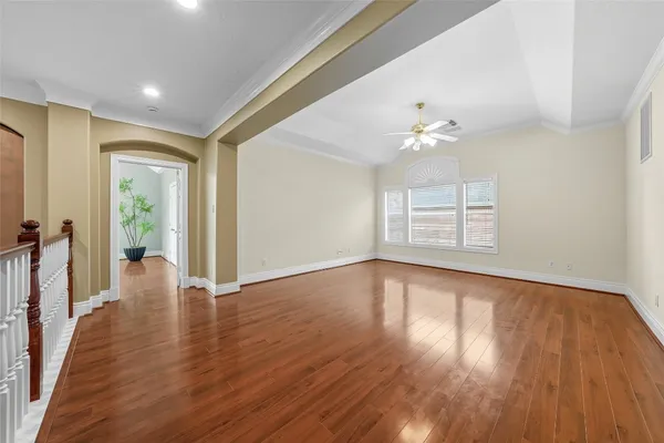 a view of empty room with wooden floor