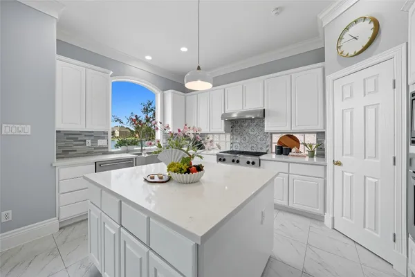 a kitchen with a sink cabinets and window