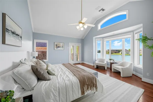 a spacious bedroom with a bed and a chandelier