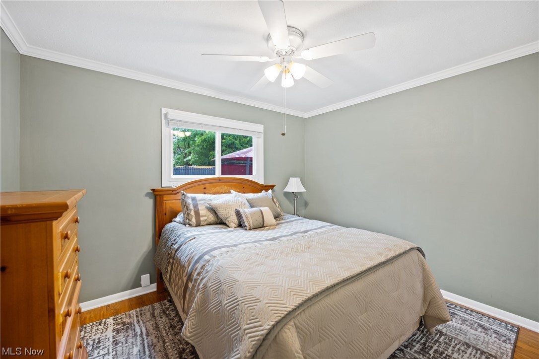 1970 Som Center Road Cleveland, OH 44124 - Photo 17 of 35 Hardwood floored bedroom with crown molding and ceiling fan