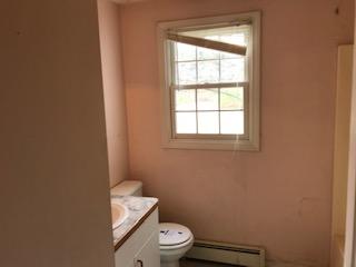 93 Dover Road Mashpee, MA 02649 - Photo 8 of 21 a bathroom with a toilet a sink and a window